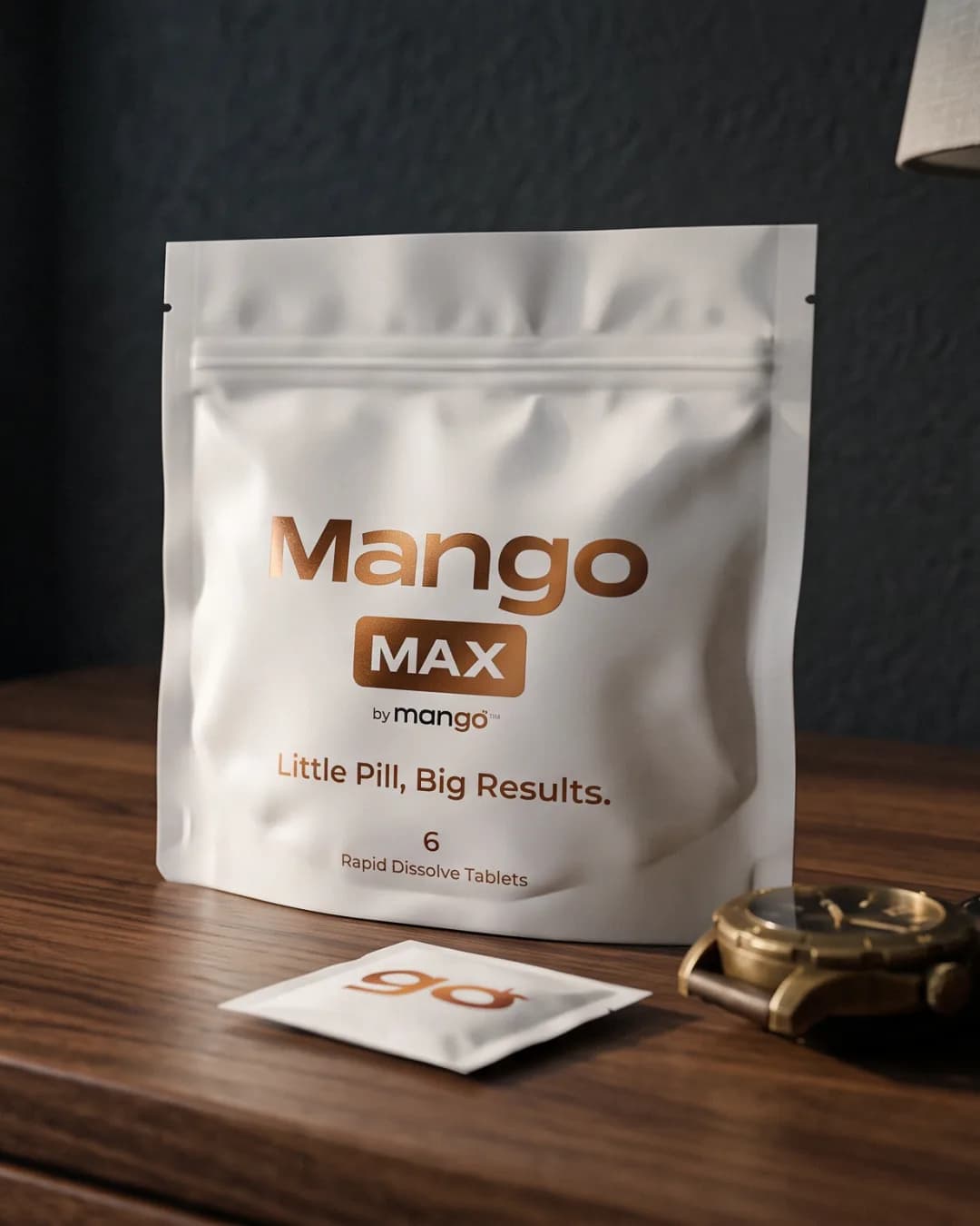 A white Mango Max pouch and a single go sachet on a nightstand
