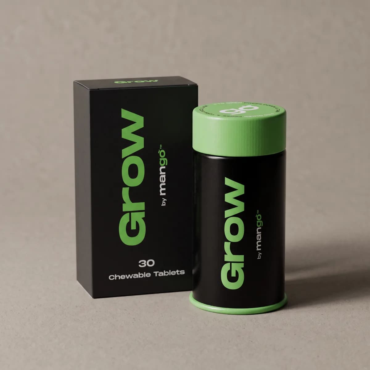 A black Grow tin with a green cap beside its box